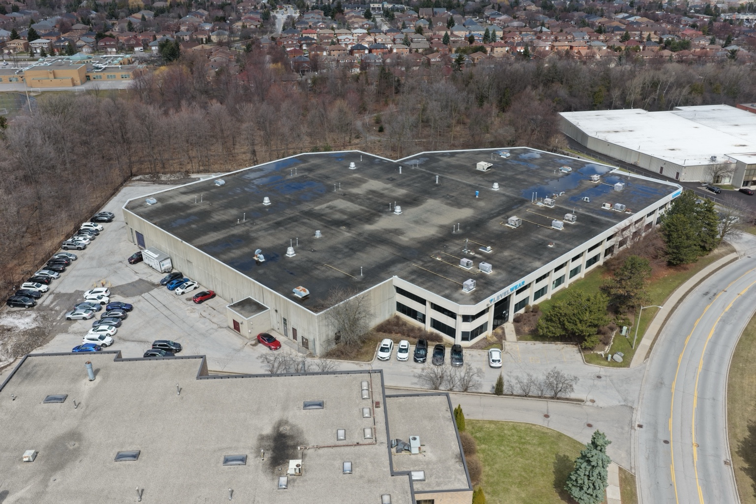 Commercial flat roof overview showing drainage and roof surface conditions